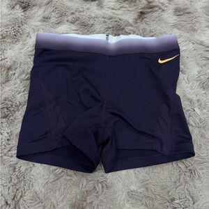 Nike Women's Dark Purple Athletic Shorts with Orange Swoosh